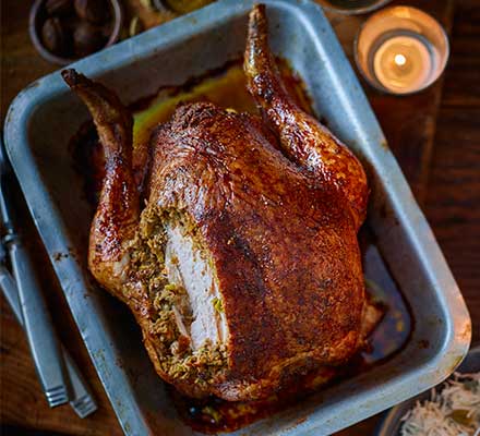 Cumin-spiced roast chicken with pork & pistachio stuffing