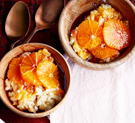 Baked cardamom-scented rice pudding with oranges in honey & pomegranate syrup