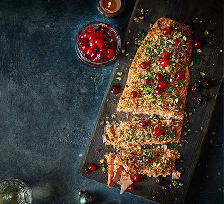 Baked salmon fillet with pickled cranberries, parsley & pistachios