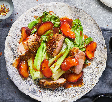 One-pan coriander-crusted duck, roasted plums & greens