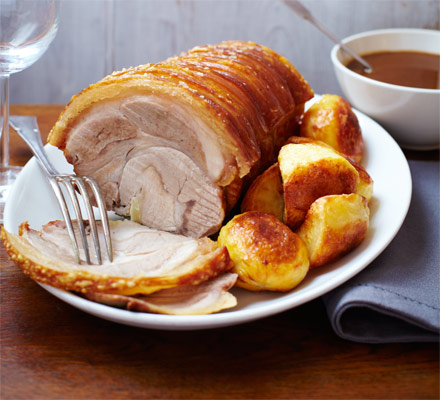 Herb-studded roast loin of pork with apple & cider gravy