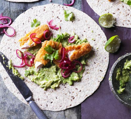 Smashed avocado with crispy chicken, pickled onions & tortillas