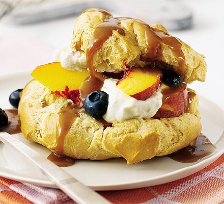 Fruit-filled choux buns with caramel sauce