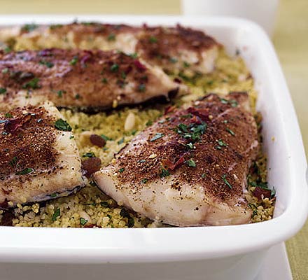 Spice-rubbed haddock fillets on orange & parsley couscous