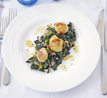 Seared scallops with flavoured greens