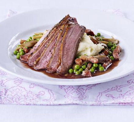 Peppered duck with vanilla mash, pea & wild mushroom ragout