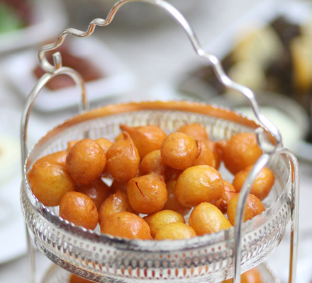 Lugaimat (deep fried sugar coated dough balls infused with cardamon and saffron)