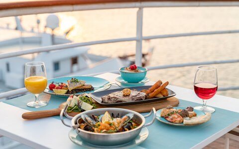 Enjoy Mediterranean delicacies at this outdoor restaurant aboard the QE2
