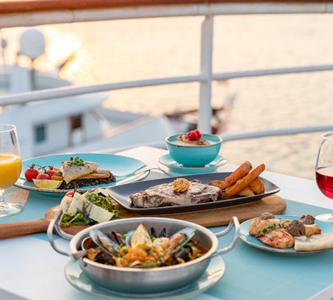 Enjoy Mediterranean delicacies at this outdoor restaurant aboard the QE2