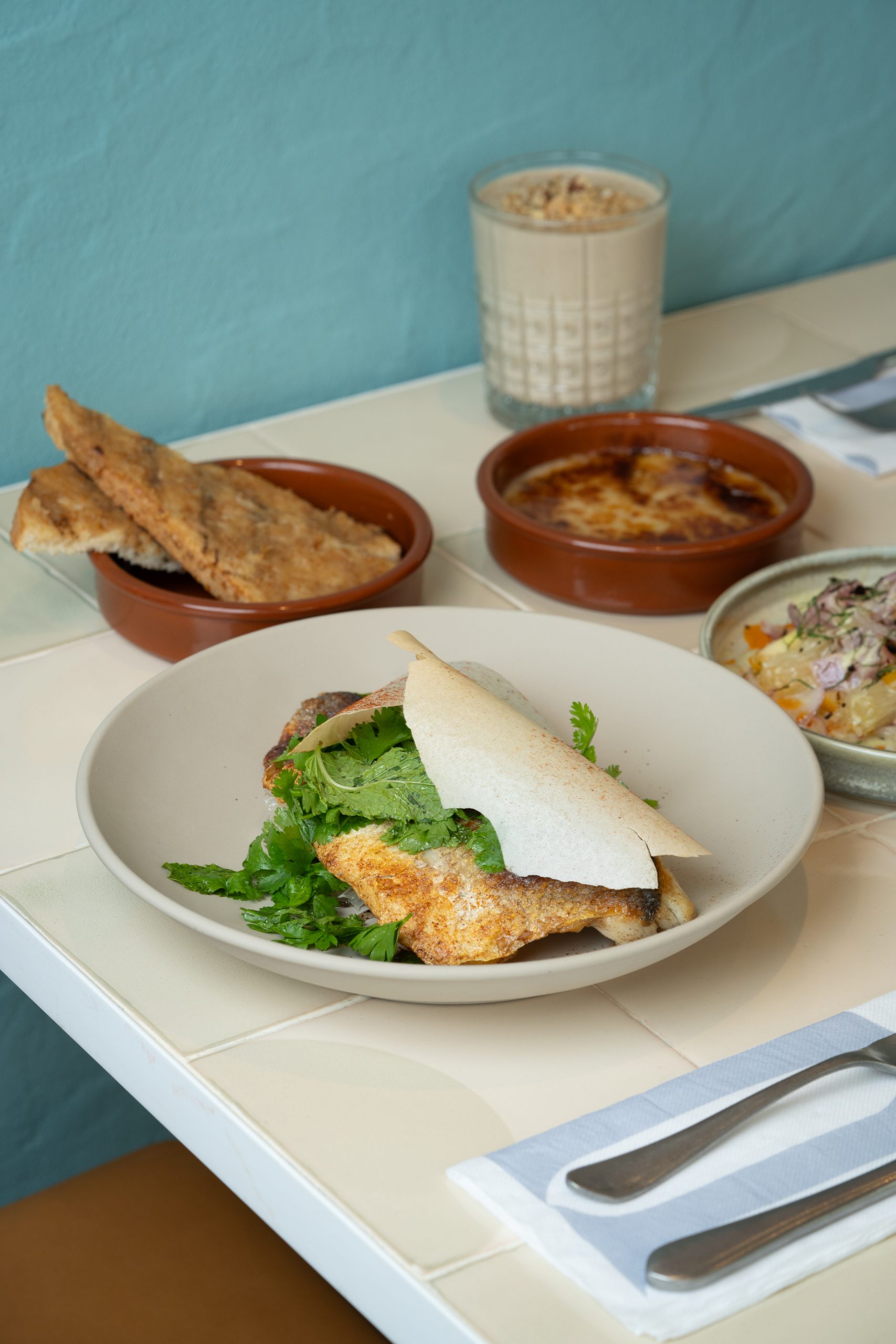 Seabass in Phyllo Puff - Grilled seabass fillet, herb salad, pomelo, greek feta, black lemon honey things to do in the UAE in January 2024